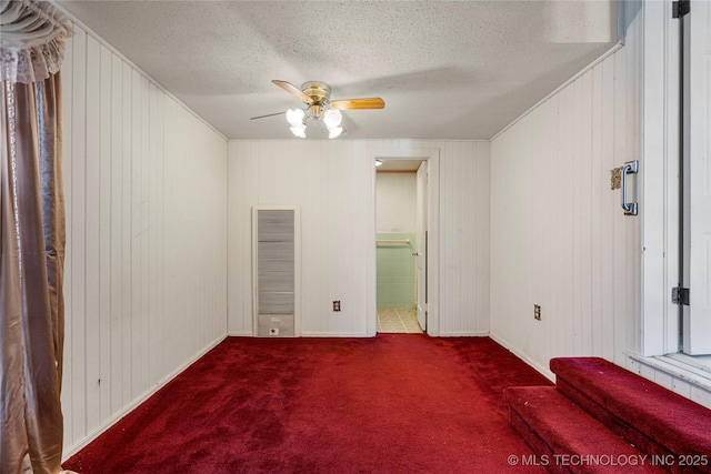 unfurnished bedroom with carpet flooring, ceiling fan, and a textured ceiling