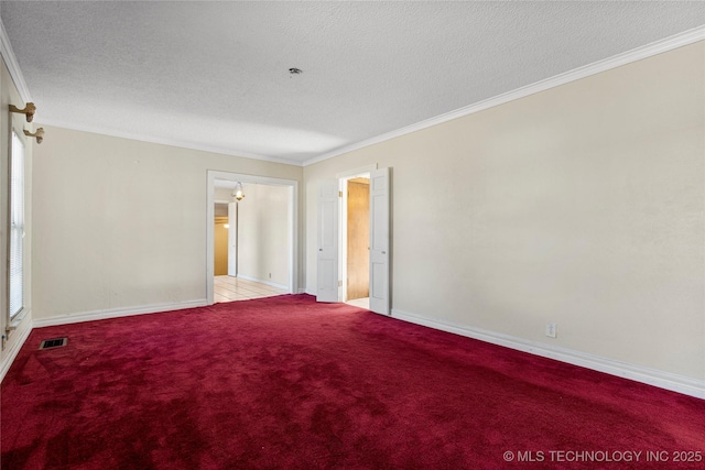 empty room with light carpet, a textured ceiling, and ornamental molding