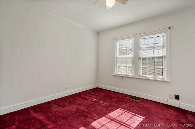 carpeted spare room featuring crown molding, ceiling fan, and a textured ceiling