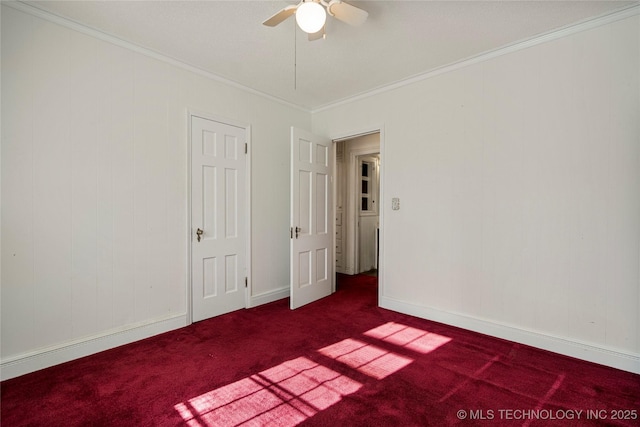 carpeted spare room with ceiling fan and ornamental molding