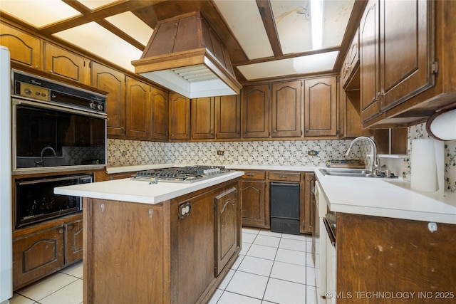 kitchen featuring custom exhaust hood, stainless steel gas cooktop, sink, a kitchen island, and light tile patterned flooring