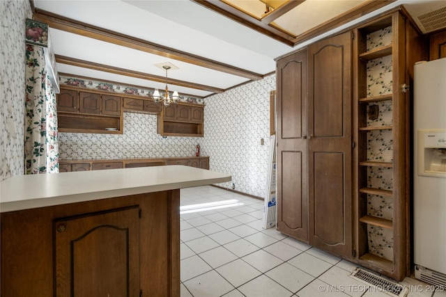 kitchen with kitchen peninsula, light tile patterned floors, decorative light fixtures, a notable chandelier, and white fridge with ice dispenser