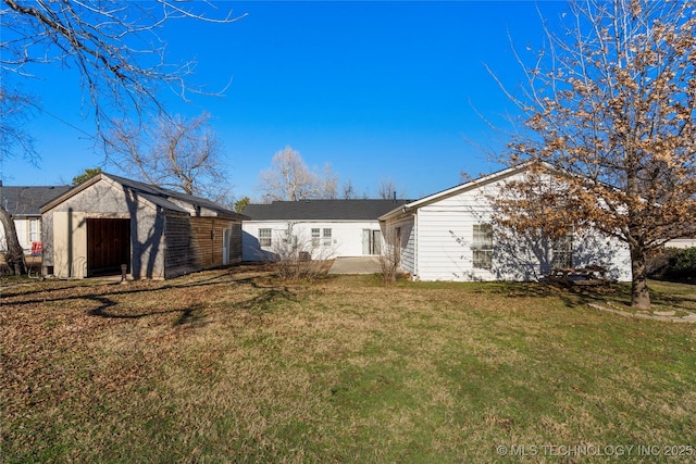 rear view of property featuring a yard