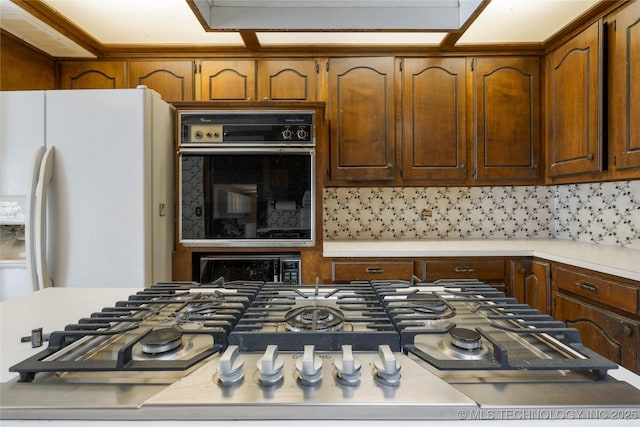 kitchen with black oven, white refrigerator, oven, and decorative backsplash