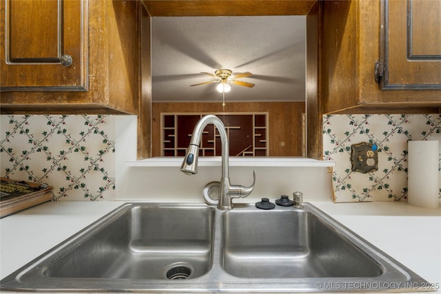 details with decorative backsplash, ceiling fan, and sink