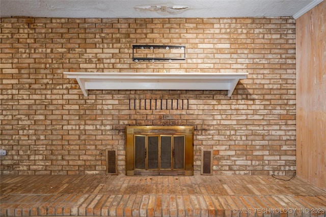 details with wood walls, a fireplace, and a textured ceiling