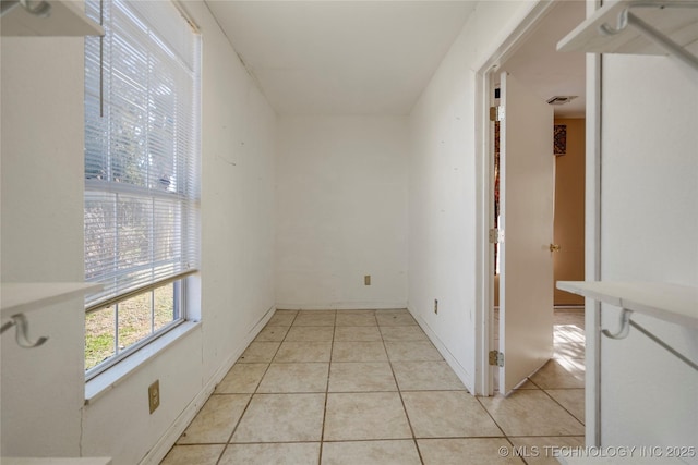 corridor with light tile patterned floors