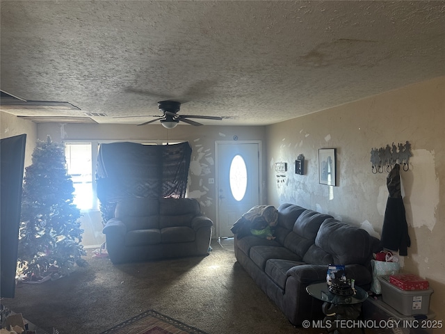 living room with a textured ceiling and ceiling fan