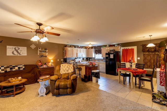 living room featuring ceiling fan and light tile patterned flooring