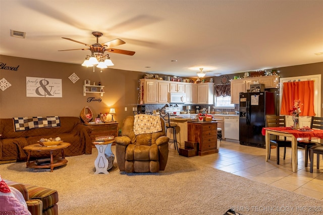 tiled living room featuring ceiling fan