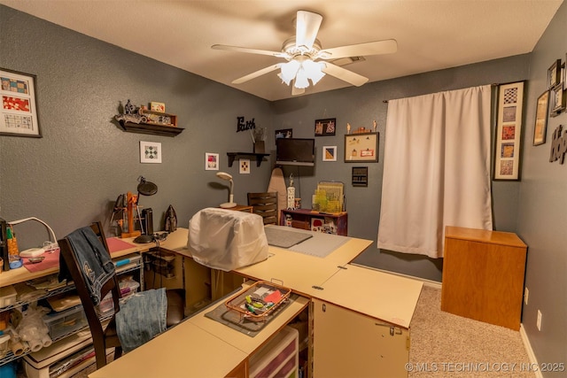 carpeted office space with ceiling fan