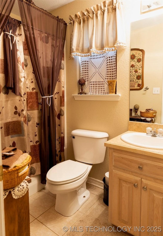 bathroom featuring tile patterned flooring, a shower with curtain, vanity, and toilet