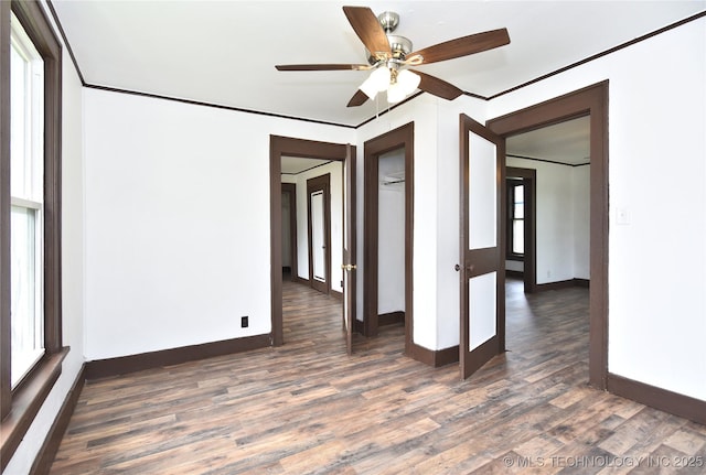 spare room featuring french doors, dark hardwood / wood-style flooring, ceiling fan, and crown molding