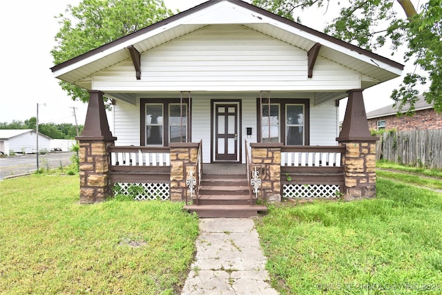 bungalow-style home featuring a porch and a front yard