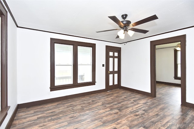 unfurnished room with crown molding, ceiling fan, and dark wood-type flooring