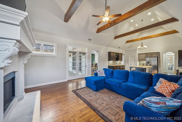 living room featuring beamed ceiling, ceiling fan with notable chandelier, dark hardwood / wood-style floors, and high vaulted ceiling