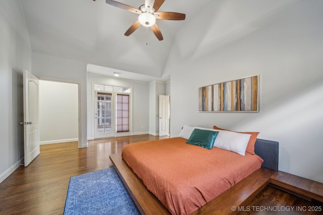 bedroom with ceiling fan, wood-type flooring, and lofted ceiling