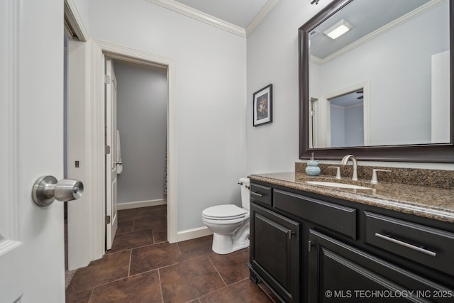 bathroom with toilet, vanity, and ornamental molding