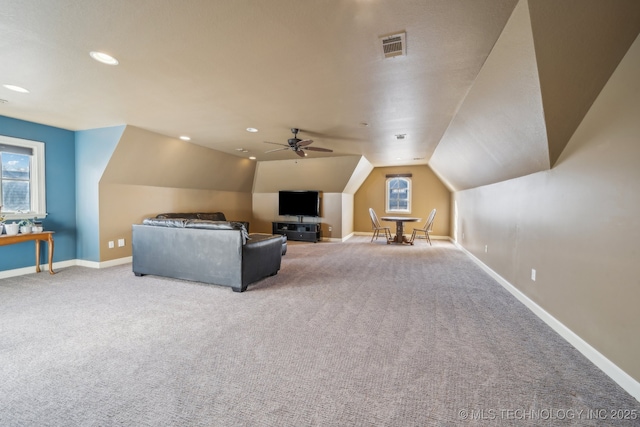 unfurnished living room featuring carpet flooring, vaulted ceiling, and ceiling fan