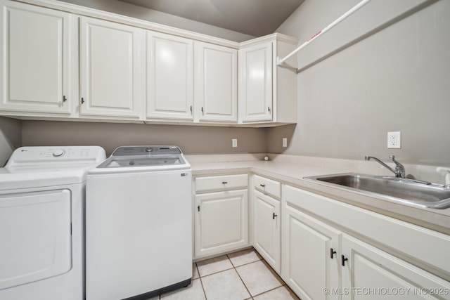 laundry room featuring cabinets, light tile patterned floors, washer and dryer, and sink