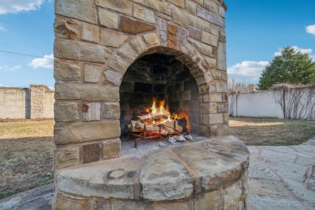 details with an outdoor stone fireplace