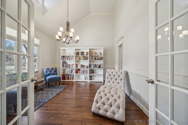 living area featuring a notable chandelier, dark hardwood / wood-style flooring, high vaulted ceiling, and french doors