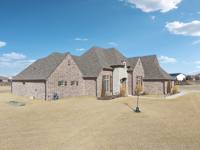 french country style house featuring a front lawn