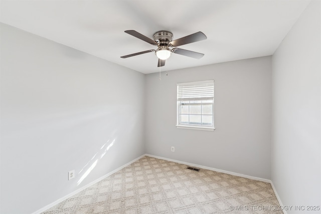 carpeted spare room featuring ceiling fan