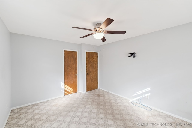 carpeted empty room featuring ceiling fan