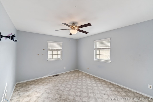 carpeted empty room featuring ceiling fan