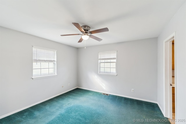 carpeted spare room with ceiling fan