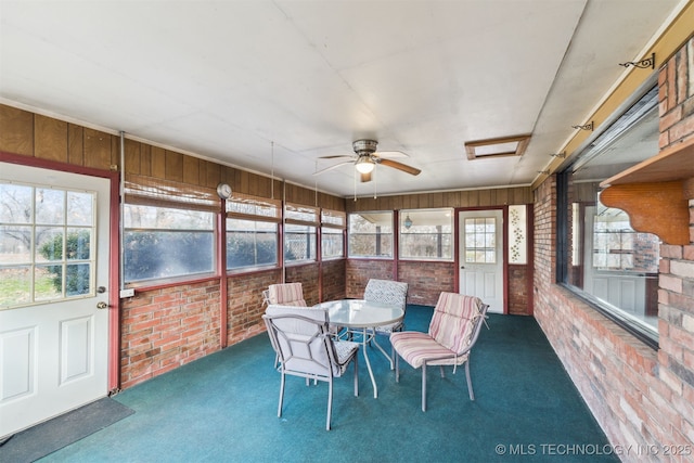 sunroom with ceiling fan and a healthy amount of sunlight