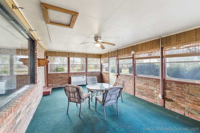 sunroom with ceiling fan and a healthy amount of sunlight