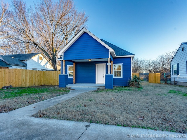 bungalow-style house with a front lawn and covered porch