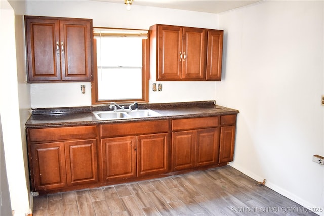 kitchen featuring light wood-type flooring and sink