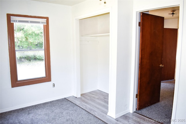 unfurnished bedroom with light hardwood / wood-style flooring and a closet