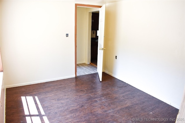 empty room with dark wood-type flooring