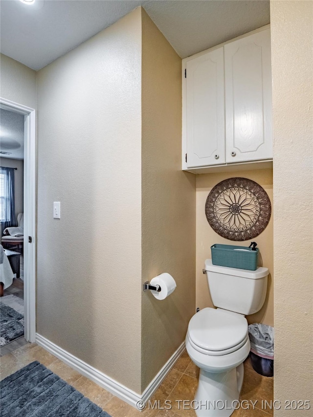 bathroom featuring tile patterned floors and toilet