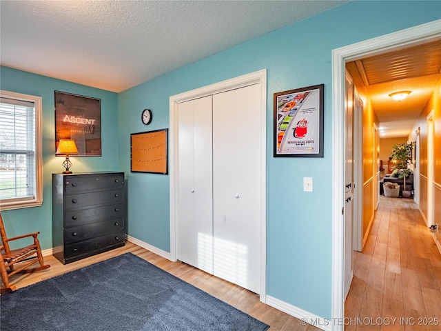 unfurnished room featuring hardwood / wood-style flooring and a textured ceiling