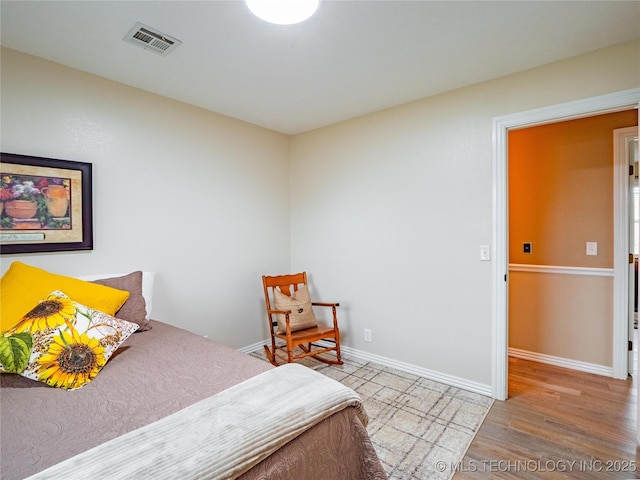 bedroom with hardwood / wood-style flooring