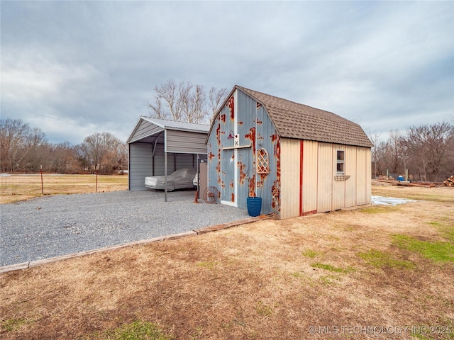 view of outbuilding with a carport and a yard