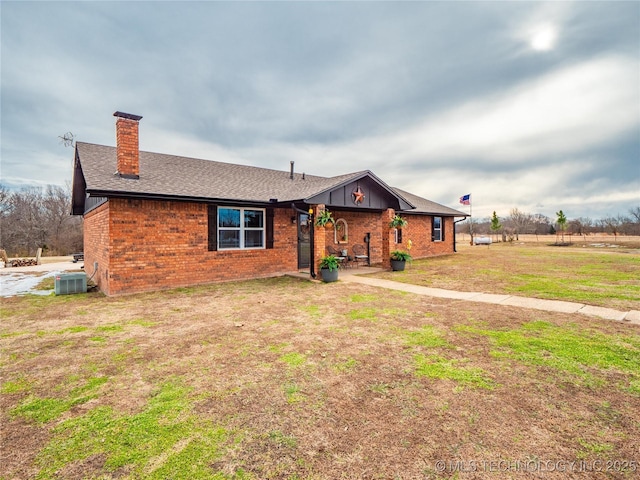 ranch-style house featuring central AC unit, a patio area, and a front lawn