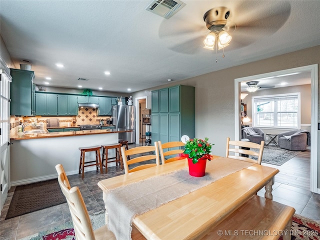 dining space featuring ceiling fan