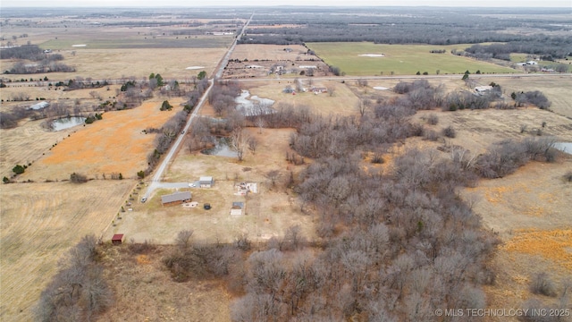 birds eye view of property featuring a water view and a rural view