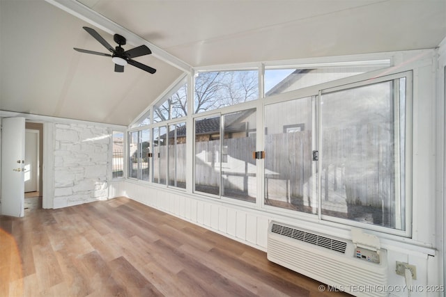 unfurnished sunroom with ceiling fan, plenty of natural light, lofted ceiling, and an AC wall unit