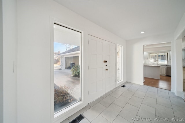 entryway featuring light tile patterned floors and a wealth of natural light