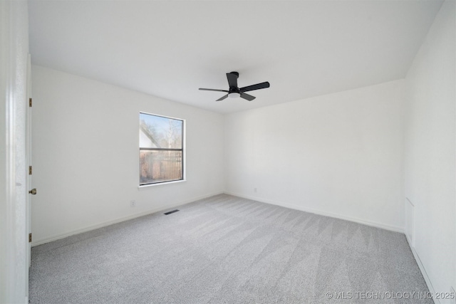 unfurnished room featuring ceiling fan and light carpet