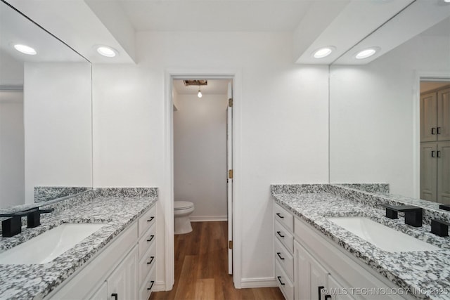 bathroom featuring hardwood / wood-style floors, vanity, and toilet