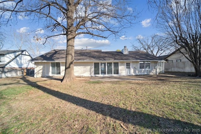 back of house with a yard