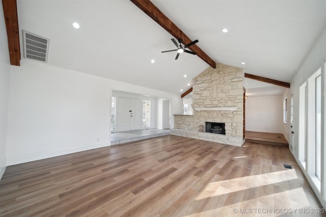 unfurnished living room with beam ceiling, ceiling fan, high vaulted ceiling, light hardwood / wood-style floors, and a fireplace